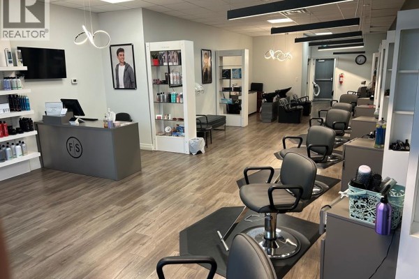 Washing station with black chairs, sinks, and organized product storage. - 2659 Howard Avenue, Windsor