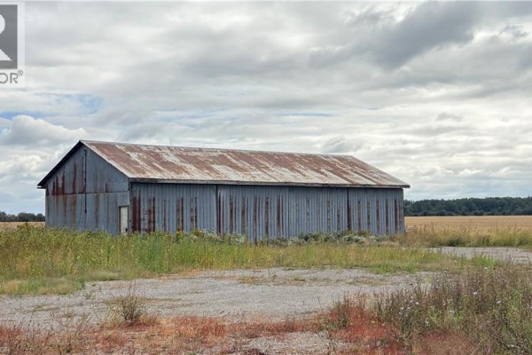 Corrugated metal barn with a rusty roof sits in a field. - 266 Haldimand Rd 9 Road, Hagersville