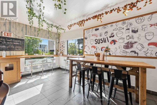 Interior seating area with wooden tables, stools, and a large sushi-themed mural. - 266 Preston Street N, Ottawa