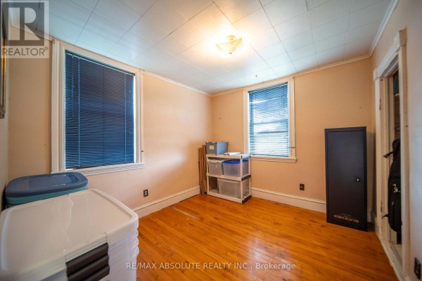 Room with hardwood floors, peach walls, safe, and storage - 2671 Champlain Street Clarence Rockland