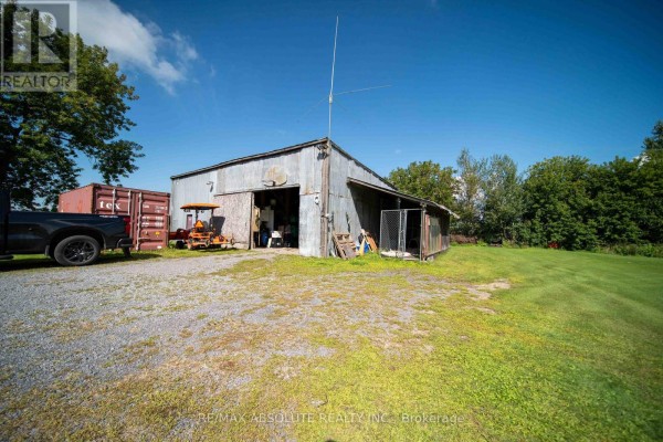 Metal barn with dog kennel, tractor, shipping container, and truck - 2671 Champlain Street Clarence Rockland