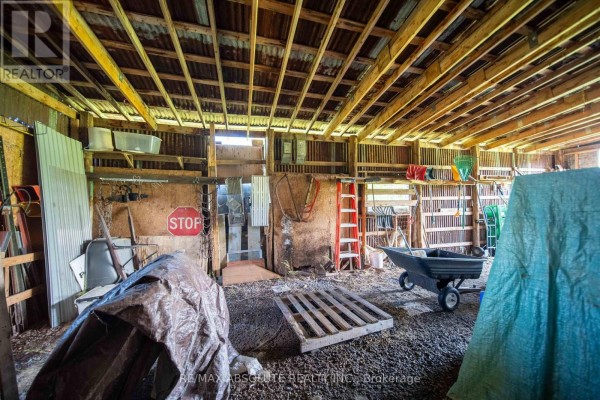 Barn interior with stop sign, ladder, wheelbarrow and tools - 2671 Champlain Street Clarence Rockland