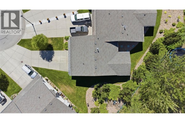 Aerial view of the roof and backyard of the duplex, showing landscaping and neighboring units. - 2675 Pine Avenue Unit# 41, Lumby