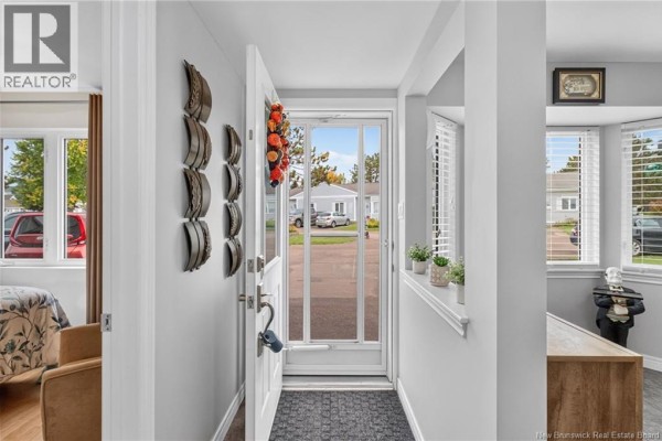 View from inside the entryway looking out the glass front door at the street. - 268 Acadie Avenue Unit# 137, Dieppe