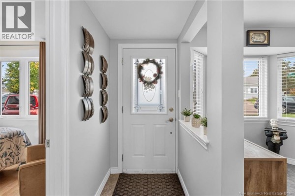 Interior entryway with light grey walls, a glass front door, and adjacent rooms. - 268 Acadie Avenue Unit# 137, Dieppe