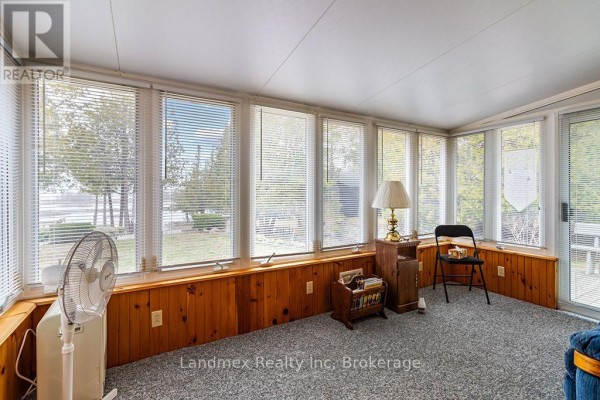 View of the main house and a detached white garage or workshop from the driveway. - 268 Dorcas Bay Road, Northern Bruce Peninsula