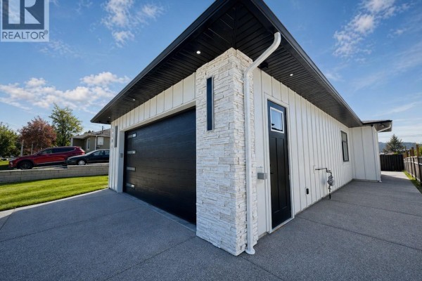 Aerial view of a modern white house with black roof and garage. - 2684 12th Ave, Port Alberni
