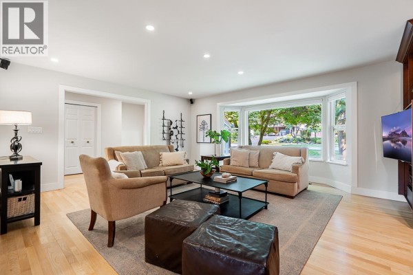 Another angle of the living room showcasing the fireplace and modern furnishings. - 2685 Byron Road, North Vancouver