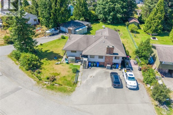 Aerial view of the house and property, showing the driveway, yard, and surrounding neighborhood. - 269 Matterson Dr, Ucluelet