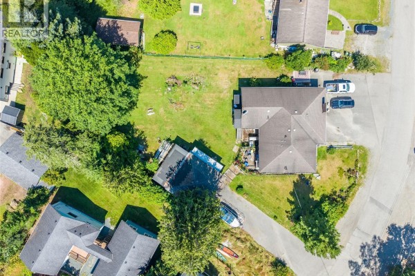 Overhead aerial view of the property, highlighting the house, yard, and nearby structures. - 269 Matterson Dr, Ucluelet