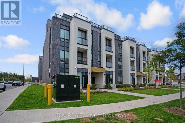 Street view of a modern townhouse complex with landscaping and utility boxes. - 27 - 3020 Trailside Drive, Oakville