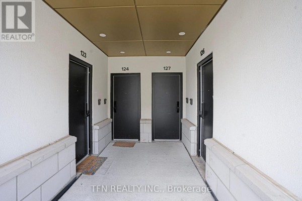 Hallway with black doors numbered 123, 124, and 127. - 27 - 3020 Trailside Drive, Oakville