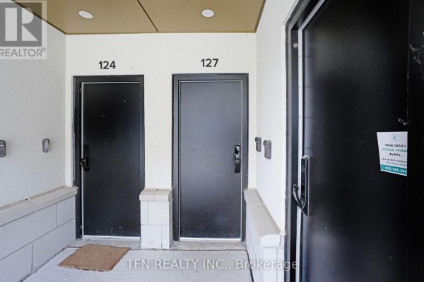 Close-up view of townhouse entrance doors numbered 124 and 127. - 27 - 3020 Trailside Drive, Oakville