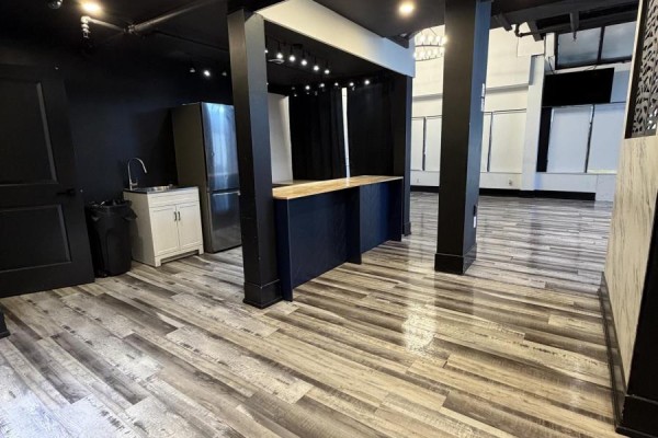 Commercial space featuring a dark blue counter, stainless steel refrigerator, sink, and wood-look flooring. - 27 - 501 Passmore Avenue, Toronto