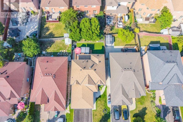 Aerial view of homes with driveways, backyards, and trees - 27 Colleyville Street Brampton