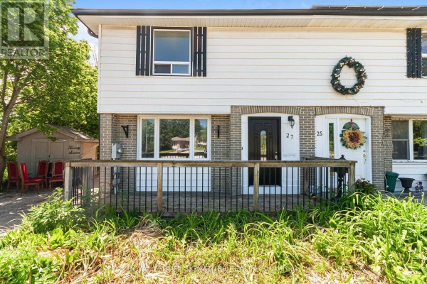 Close-up of the front entrance of a white and brick semi-detached house with a wooden deck. - 27 Daphne Crescent, Barrie