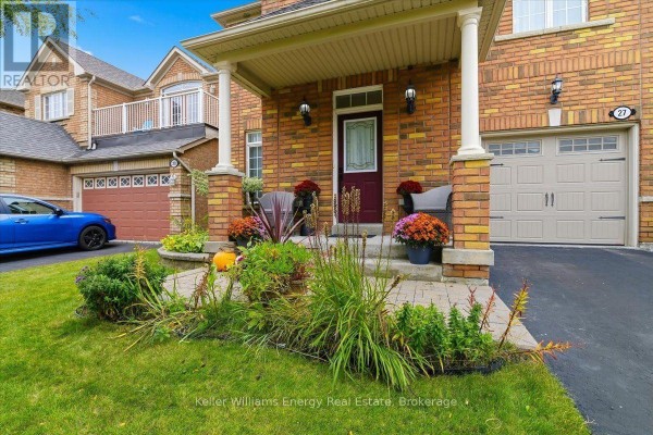 Close-up of the covered front porch of a brick house with seasonal decorations and seating. - 27 Dent Street, Ajax