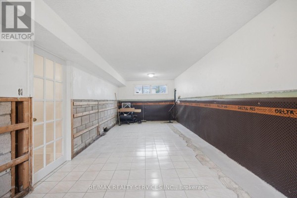 Tiled basement with glass door and waterproofing membrane - 27 Edgemont Drive Brampton