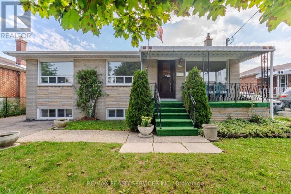 Brick house exterior with covered porch and green stairs - 27 Edgemont Drive Brampton