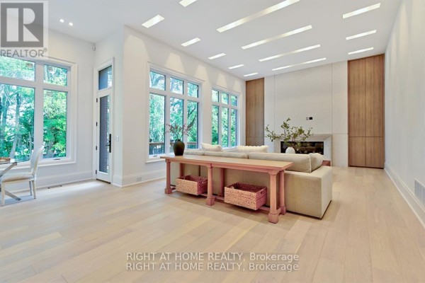 Living room with large windows, fireplace, and modern ceiling lights - 27 Hurlingham Crescent Toronto
