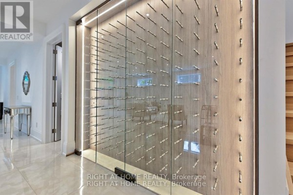 Glass wine cellar with wood paneling and LED lighting - 27 Hurlingham Crescent Toronto