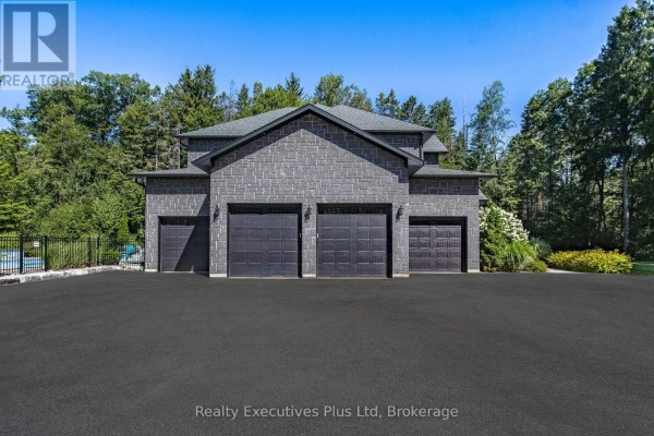 Covered porch with dark wooden beams and stone walls, leading to a glass-paned door. - 27 Kingfisher Crescent, Tiny