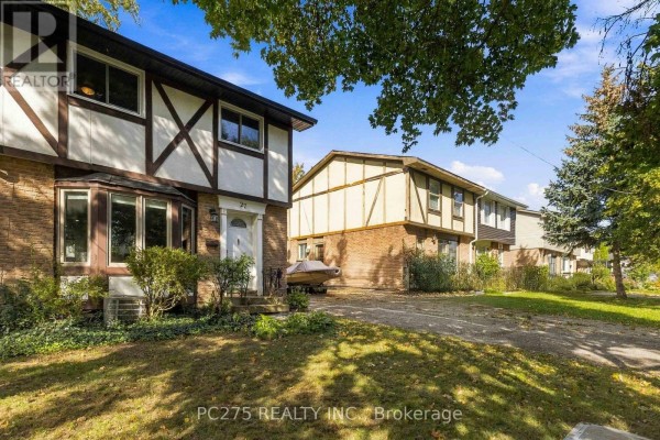 Exterior view of the right side of a Tudor-style home and driveway. - 27 Sasha Crescent, London South