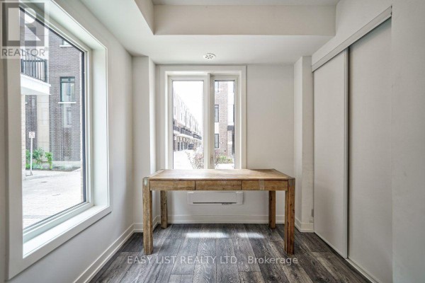 Bedroom with a single bed, cactus-patterned pillows, and large windows. - 27 Spruce Pines Crescent, Toronto