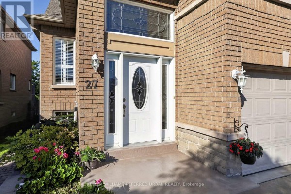 Close-up of the white front door with oval glass insert and decorative transom window. - 27 Summer Valley Drive, Brampton