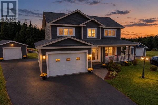 Exterior of a dark grey house with white trim, two garage doors, and a covered porch at dusk. - 27 Summerwood Place, Portugal Cove St  Philips