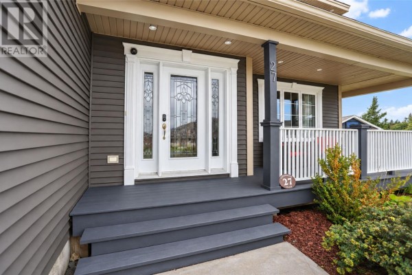 Front entrance of a house with a dark grey porch, white steps, and a glass-paneled front door. - 27 Summerwood Place, Portugal Cove St  Philips