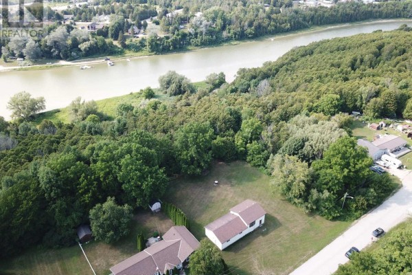 Aerial view of houses surrounded by trees, with a wide river in the background. - 270 Edward Street, Saugeen Shores