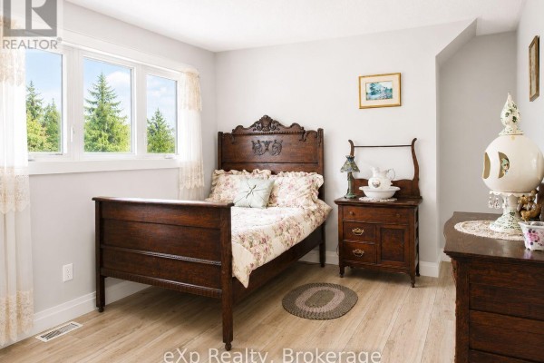 Antique wooden bed and washstand in bedroom - 271 River Road Grey Highlands