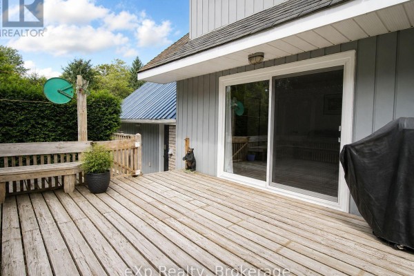 Wooden deck with bench, sliding door, grill, bear statue - 271 River Road Grey Highlands
