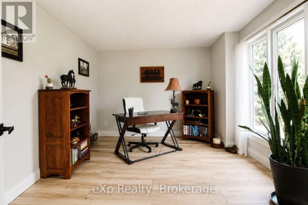 Office with wooden desk, bookshelves, and large window - 271 River Road Grey Highlands