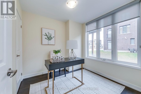 Small office room with a desk, chair, large window, and dark hardwood floors. - 272 Squire Crescent, Oakville
