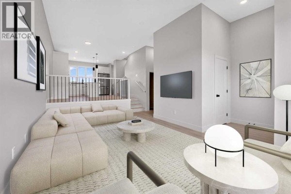 Living room with a sectional sofa, coffee table, and contemporary art on the wall. - 2720 16 Avenue, Coaldale