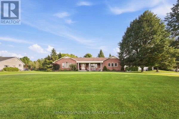 Exterior view of a long brick house with a manicured front yard. - 2725 Mcintosh Road, Augusta