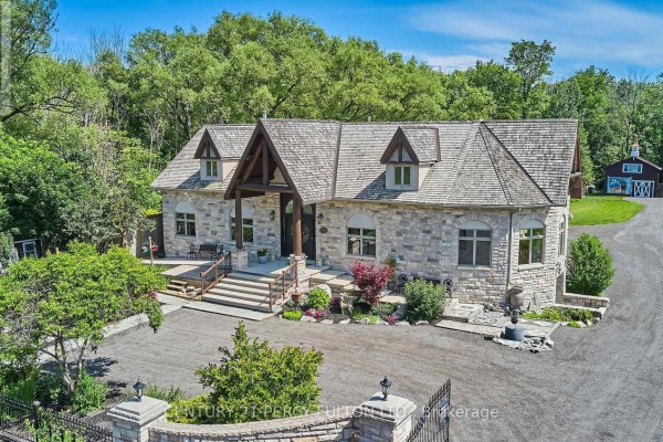 Front entrance with stone steps, large door, and landscaped yard. - 2733 Taunton Road, Clarington