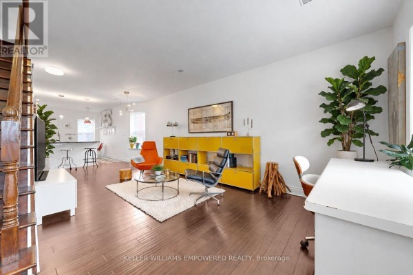 Living room, dining area, and kitchen with hardwood floors and white walls. - 274 Wallace Avenue, Toronto