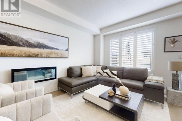 A bedroom with a metal-frame bed, a desk with a computer, and a guitar mounted on the wall. - 2747 Peter Matthews Drive, Pickering