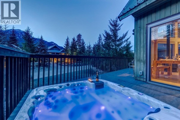 Outdoor hot tub on a wooden deck with mountain views. - 2748 Coyote Place, Whistler