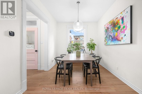 View from the dining room, looking toward the entryway with a pink door. - 275 Arlington Avenue, Ottawa
