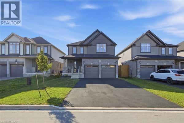 Street view of a modern two-story house at 275 Bradshaw Drive with adjacent homes and a paved driveway. - 275 Bradshaw Drive, Stratford