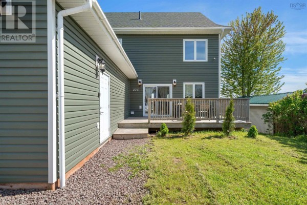 Hallway with grey walls, a white cabinet, and an open doorway to a bathroom. - 275 High Street, Pictou