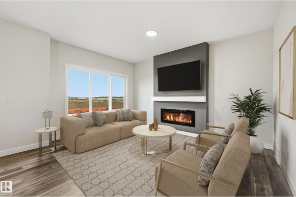Living room with a beige sofa, two armchairs, a coffee table, and a gas fireplace. - 276 Lodge Pole Pl, Leduc