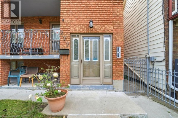 Close-up of the double front doors with glass panels and adjacent windows. - 277 Harvie Avenue, York