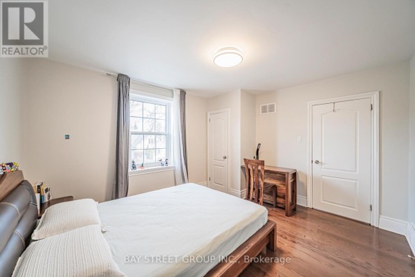 Living room with piano, hardwood floors, and decorative elements like a chandelier. - 277 Lawrence Avenue E, Toronto