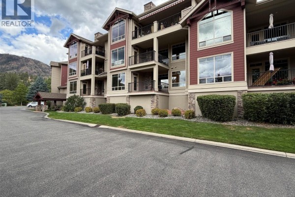 Exterior view of the apartment building showing multiple balconies and large windows. - 2770 Auburn Road Unit# 107, West Kelowna