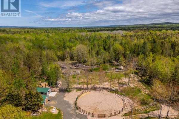 Aerial shot of riding arena and mobile home, surrounded by dense forest. - 278 Fitch Road, Clarence East